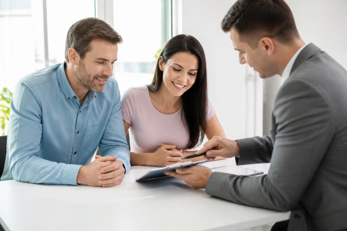 Homeowners reviewing mortgage protection insurance costs with an advisor